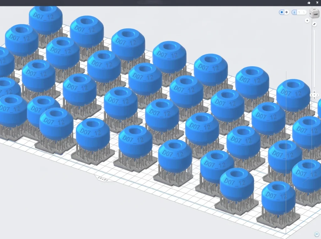 3D print view of several additively manufactured rotary nozzle components on the print bed